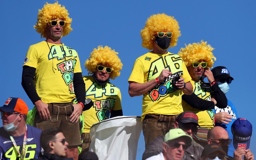 epa09570153 Supporters of Italian MotoGP rider Valentino Rossi of Petronas Yamaha SRT Team cheer during the Algarve Motorcycling Grand Prix at the Algarve International race track in Portimao, Portuga ...