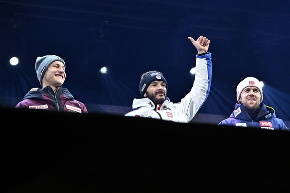 Cyprien Sarrazin of France, winner, center, Marco Odermatt of Switzerland, 2nd place, left, and Aleksander Aamodt Kilde, of Norway, 3rd place, celebrate during the award ceremony after the men's ...