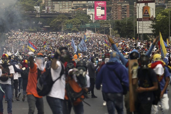 Thousands of opponents of President Nicolas Maduro march in Caracas, Venezuela, Wednesday, April 26, 2017. Security forces blocked anti-government protesters that attempted to march to the Ombudsman&# ...