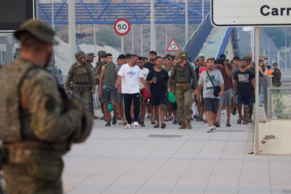 Escorted by the Spanish army, migrants who crossed into Spain return to Morocco from the Spanish enclave of Ceuta on Saturday, Aug. 1, 2026. (AP Photo/Antonio Sempere)
Spain Ceuta