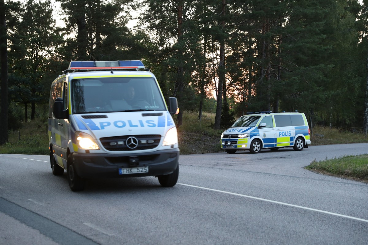 Two police cars leave the area at Hallby prison, near Eskilstuna, Sweden, Wednesday, July 21, 2021. Inmates abducted two prison officers after breaking into a guards' room soon after midday and c ...