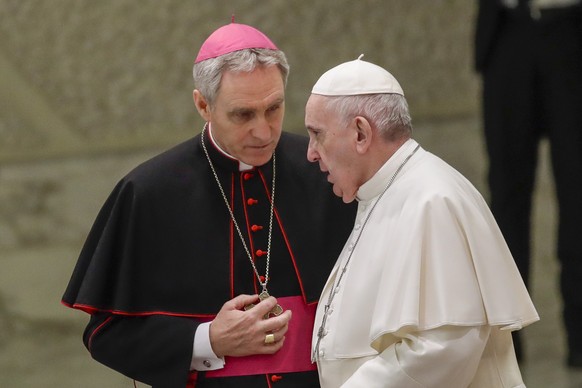 FILE - Pope Francis talks with Papal Household Archbishop Georg Gaenswein during his weekly general audience, in Paul VI Hall at the Vatican, on Jan. 15, 2020. The longtime secretary to Pope Benedict  ...