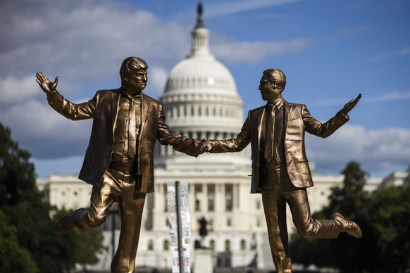epaselect epa12425982 A statue depicting US President Donald Trump (L) holding hands with disgraced financier and child sex offender Jeffrey Epstein (R) returns to the National Mall in Washington, DC, ...