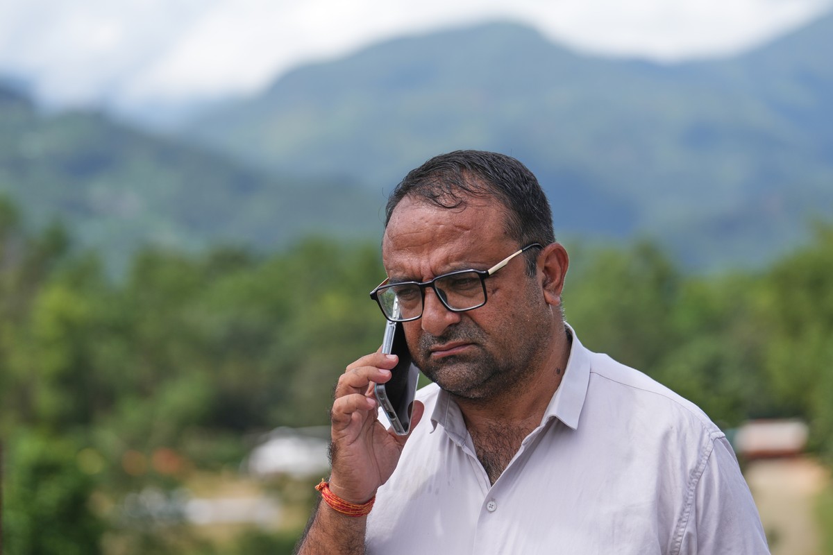 Rajendra Dawadi, a school teacher of Tribhuvan Trishuli Secondary School, talks on his mobile phone in Trishuli Valley in Nepal's Nuwakot district, Monday, Aug. 31, 2026. (AP Photo/Rajesh Kumar S ...