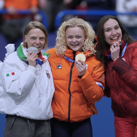 From left to right, silver medalist Arianna Fontana of Italy, gold medalist Xandra Velzeboer of the Netherlands and bronze medalist Courtney Sarault of Canada receive their medals after the short trac ...