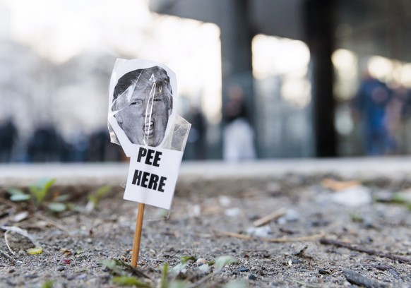 epa10558392 A small photo of former President Donald J. Trump outside Manhattan Criminal Court in New York City, New York, U.S., April 4, 2023. A Manhattan grand jury voted to indict former President D...