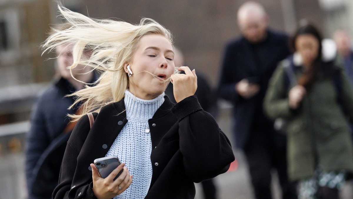 epa11849718 A woman walks over London Bridge as Storm Eowyn brings strong gusts to London, Britain, 24 January 2025. The UK Met Office has issued weather warnings, including a rare red one, due to Sto ...