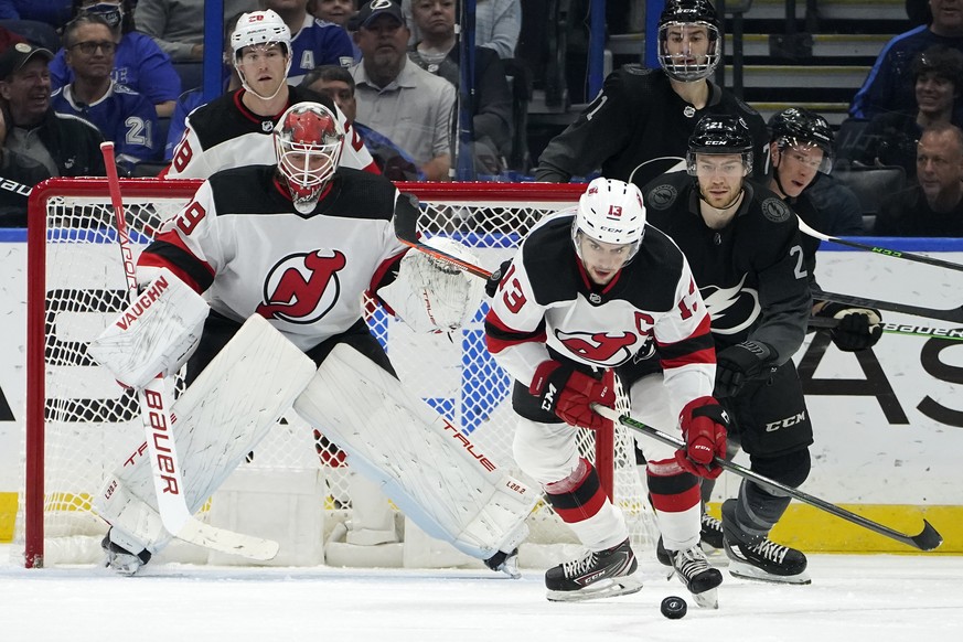 New Jersey Devils center Nico Hischier (13) intercepts a pass intended for Tampa Bay Lightning center Brayden Point (21) in front of goaltender Mackenzie Blackwood (29) during the first period of an N ...