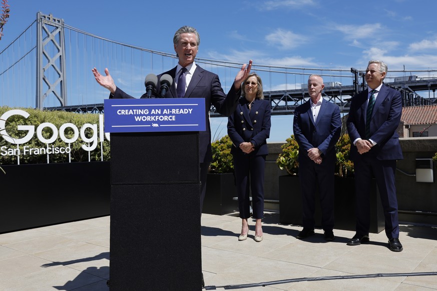 epa12289114 California Governor Gavin Newsom responds to media questions after signing agreements with technology companies in the GenAI sector, including Google, Adobe, IBM and Microsoft, to help pre ...