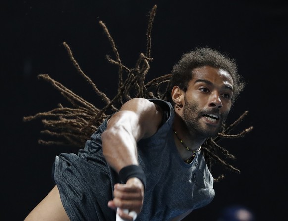 Germany&#039;s Dustin Brown serves to Portugal&#039;s Joao Sousa during their first round match at the Australian Open tennis championships in Melbourne, Australia, Monday, Jan. 15, 2018. (AP Photo/Ng ...