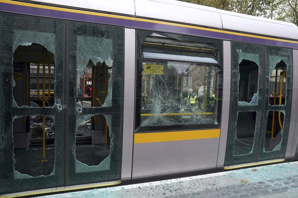 A damaged Luas with windows smashed and covered in debris is seen on O'Connell Street in the aftermath of violent scenes in the city center on Thursday evening, in Dublin, Friday 24 November 2023. ...