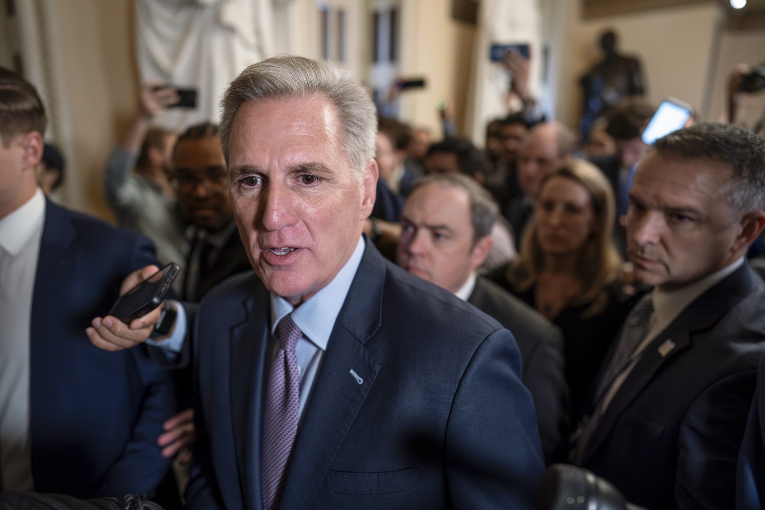 Speaker of the House Kevin McCarthy, R-Calif., is surrounded by press and police on the way to the chamber, at the Capitol in Washington, Tuesday, Oct. 3, 2023. McCarthy?s ability to remain in leaders ...