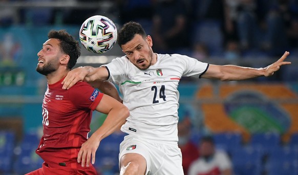 epa09263271 Hakan Calhanoglu (L) of Turkey in action against Alessandro Florenzi of Italy during the UEFA EURO 2020 group A preliminary round soccer match between Turkey and Italy at the Olympic Stadi ...