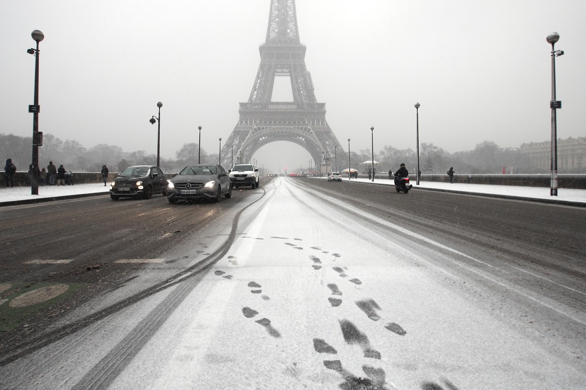 Footprints are visible on Iena bridge after snow starts to fall in Paris, France, Tuesday, Feb. 6, 2018. France's national weather agency Meteo France said Tuesday about half the country is on al ...