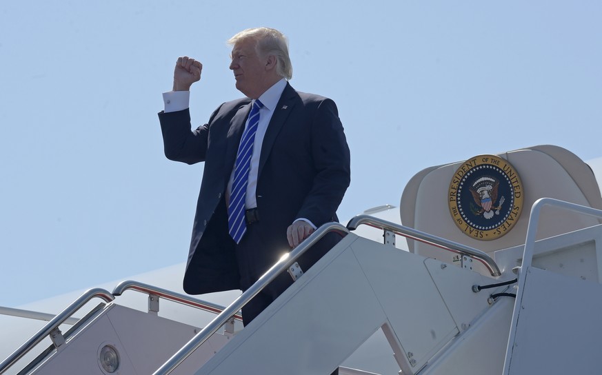 President Donald Trump gestures as he walks off Air Force One at Groton-New London Airport in Groton, Conn., Wednesday, May 17, 2017. Trump is giving the commencement address at the U.S. Coast Guard A ...