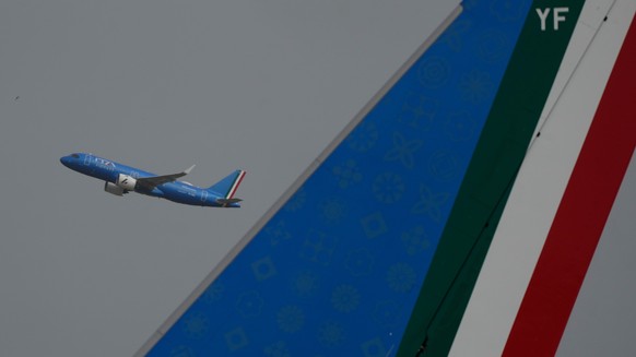 The tail of the plane carrying Pope Leo XIV to Algiers, right, is seen against the backdrop of an ITA Airways flight taking off from Romes Leonardo da Vinci-Fiumicino International Airport on Monday, ...