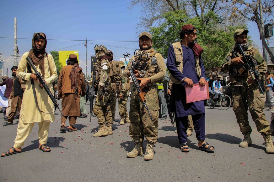 epa09887707 Taliban stand guard as civil society activists visit the Iranian embassy to show solidarity with Iran, in Kabul, Afghanistan, 13 April 2022. The visit comes following protests against Iran ...
