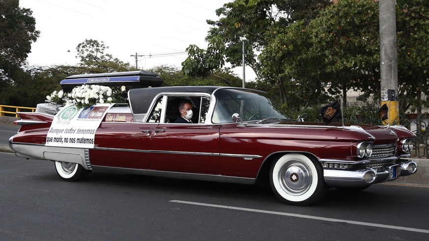 epa08331042 A hearse drives along a street as part of a campaign, carried out by the Colombian National Police and the San Vicente funeral home, calling for residents to stay home, in Medellin, Colomb ...