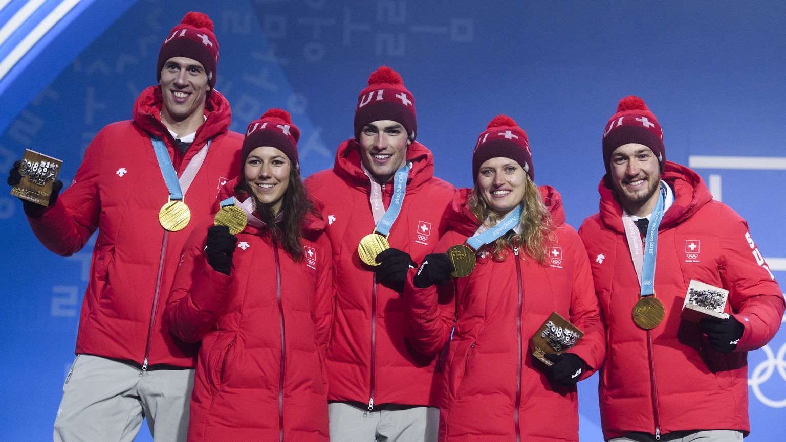 Gold medal winner Team Switzerland with Ramon Zenhaeusern, Wendy Holdener, Daniel Yule, Denise Feierabend, and Luca Aerni, from left, pose during the victory ceremony on the Medal Plaza for the alpine ...