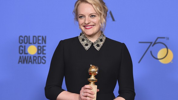 Elisabeth Moss poses in the press room with the award for best performance by an actress in a television series - drama for &quot;The Handmaid&#039;s Tale&quot; at the 75th annual Golden Globe Awards  ...