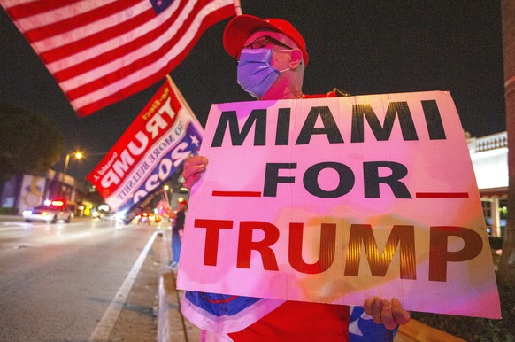 epaselect epa08797219 US President Donald J. Trump?s supporters celebrate in front of the Versailles restaurant in Miami, Florida, USA, 03 November 2020. Americans vote on Election Day to choose betwe ...