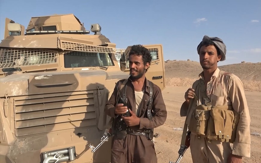 epa13226214 A handout screen grab taken from an undated video released on 09 September 2026 made available by the Houthi military media center shows Houthi fighters inspecting a damaged armored vehicl ...