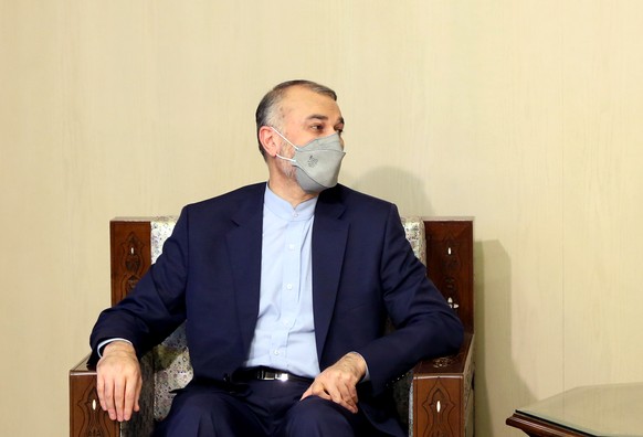 epa09435279 Iranian Foreign Minister Hossein Amir-Abdollahian looks on under a portrait of Syrian President Bashar Assad during a meeting with his Syrian counterpart in Damascus, Syria, 29 August 2021 ...