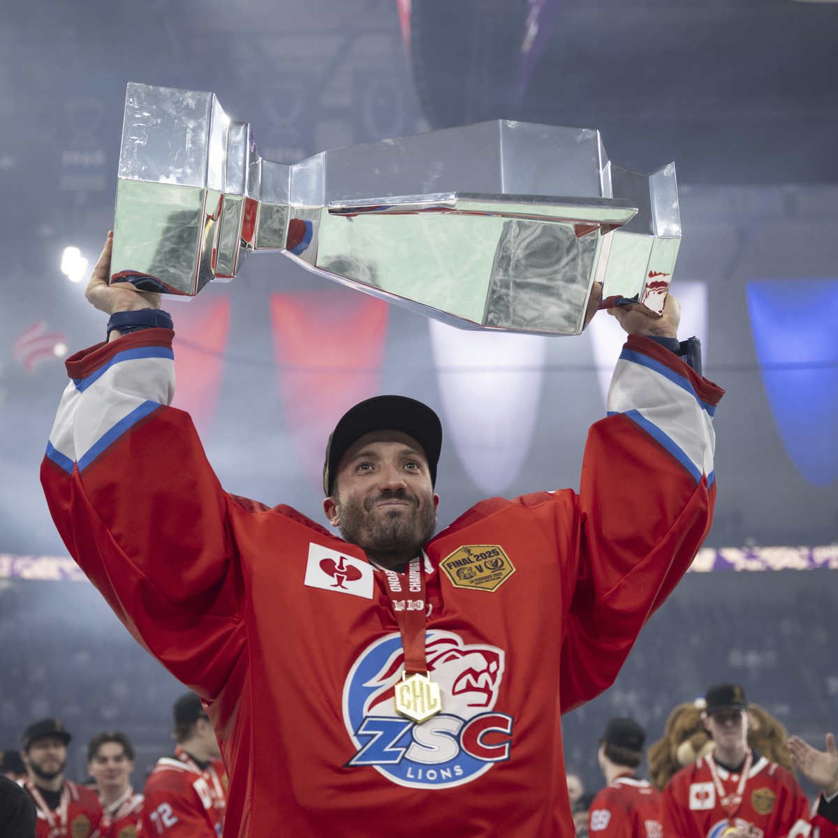 ZSC Zurich goalkeeper Simon Hrubec celebrates with the trophy after defeating Farjestad Karlstad in the Champions Hockey League final game between Switzerland's ZSC Zurich and Sweden's Farje ...