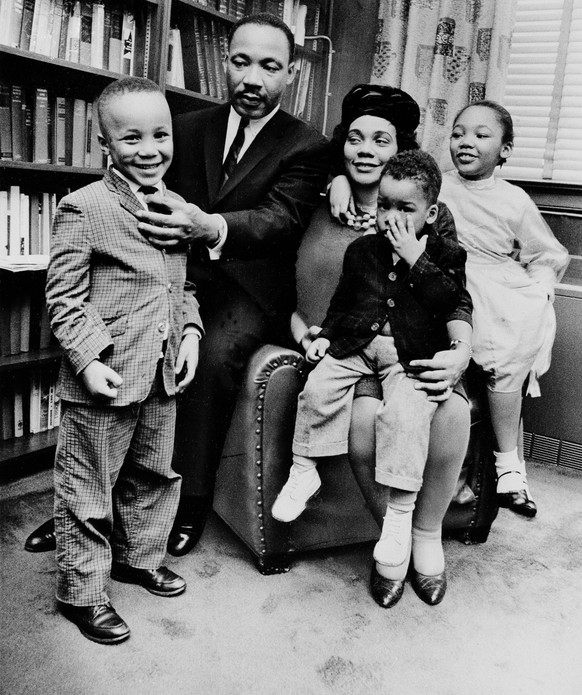 FILE - In this March 17, 1963, file photo, Dr. Martin Luther King Jr. and his wife, Coretta Scott King, sit with three of their four children in their Atlanta, Ga., home. From left are: Martin Luther  ...