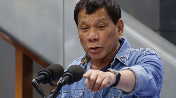 Philippine President Rodrigo Duterte jokes while addressing Filipino Overseas Workers who were repatriated from Kuwait Tuesday, Feb. 13, 2018 at the Ninoy Aquino International Airport in suburban Pasa ...