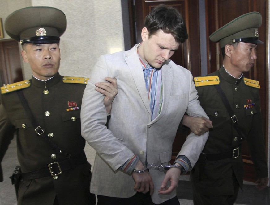 FILE - In this March 16, 2016, file photo, American student Otto Warmbier, center, is escorted at the Supreme Court in Pyongyang, North Korea. Warmbier, an American college student who was released by ...