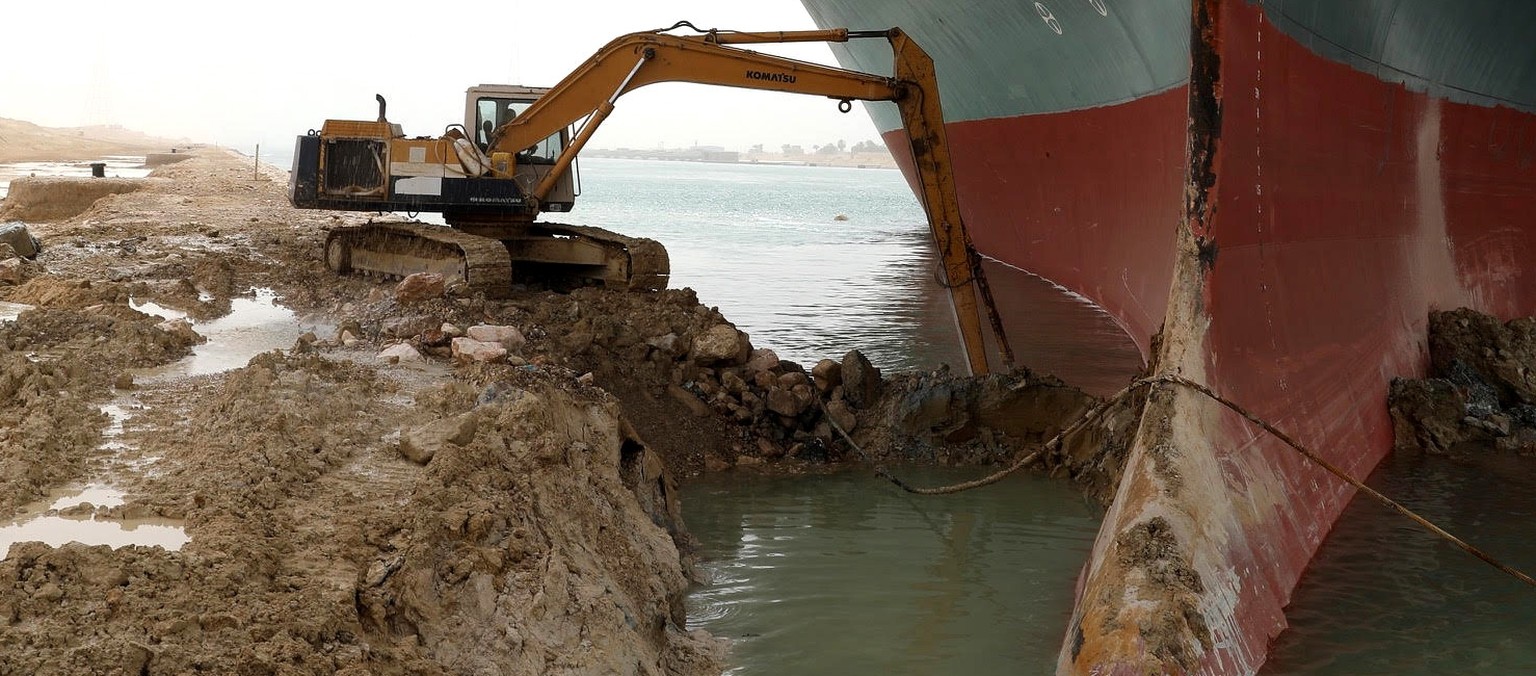 epa09095862 A handout photo made available by the Suez Canal Authority, shows the Ever Given container ship which ran agorund in the Suez Canal, Egypt, 25 March 2021. The Ever Given, a large container ...