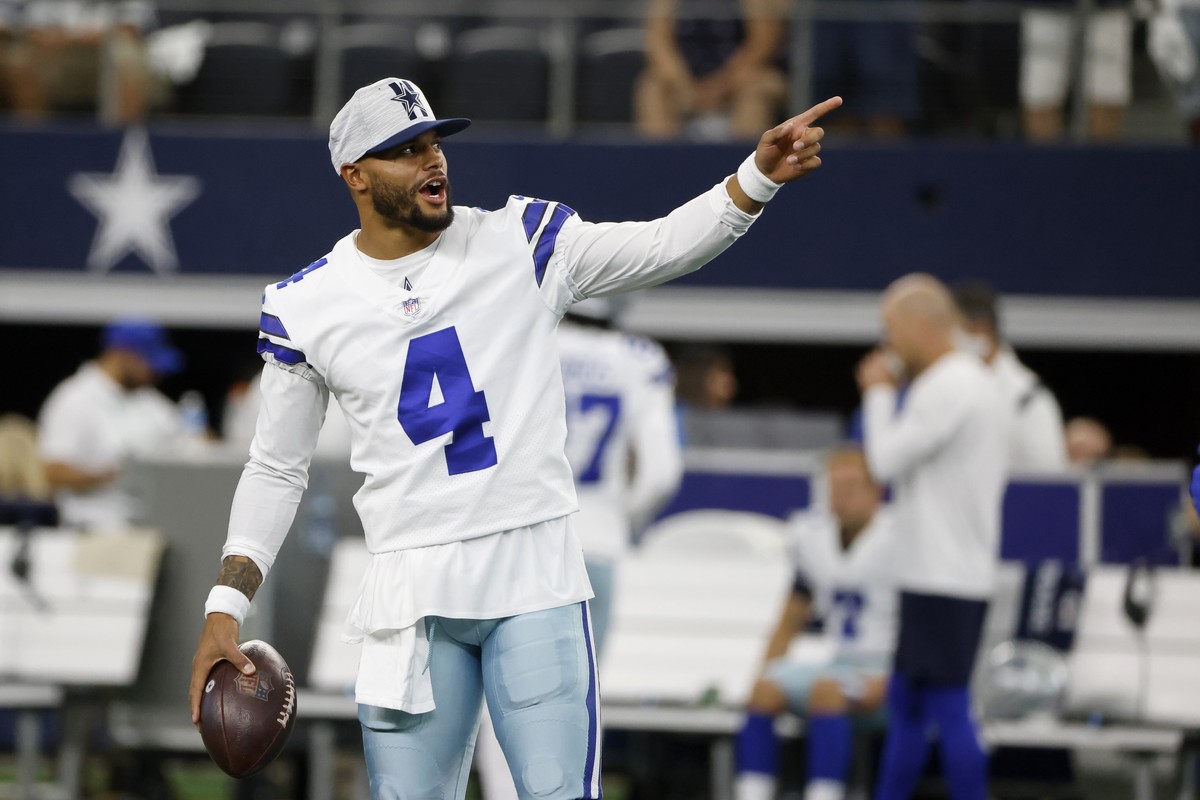 Dallas Cowboys' Dak Prescott gestures as he stands on the field during warmups before a preseason NFL football game against the Houston Texans in Arlington, Texas, Saturday, Aug. 21, 2021. (AP Ph ...
