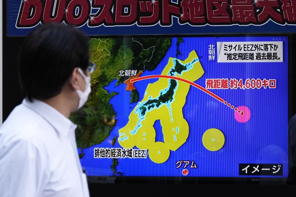 epa10222094 A pedestrian stops to watch a screen displaying news reporting of North Korea&#039;s launch of a ballistic missile in Tokyo, Japan, 04 October 2022. North Korea launched a ballistic missil ...