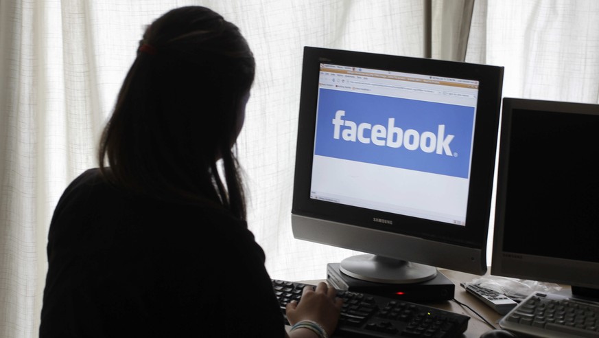 FILE - In this Monday, June 4, 2012, file photo, a girl looks at Facebook on her computer in Palo Alto, Calif. &quot;Fake news,&quot; which has gotten a lot of attention for its potential role in sway ...