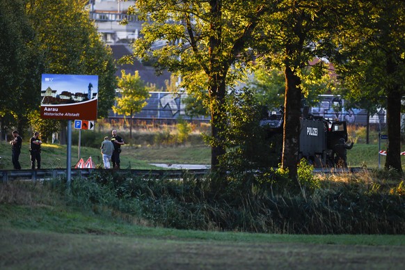 epa13199572 Armed police officers block a street near the Schachen horse racing track following a shooting during a rave event at the Schachen horse racing track near Aarau, Switzerland, 30 August 202 ...