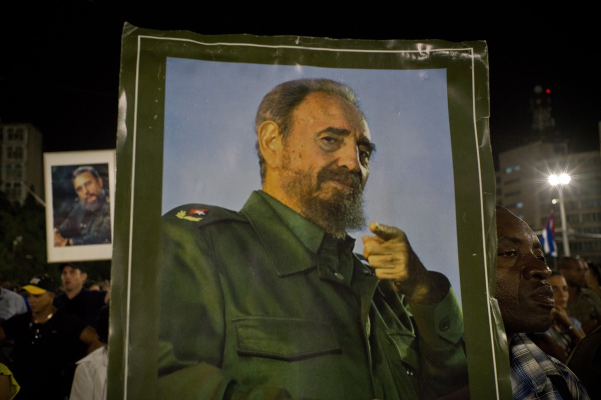 A picture of Fidel Castro is held during a rally honoring the late Cuban leader at the Revolution Plaza in Havana, Cuba, Tuesday, Nov. 29, 2016. Schools and government offices were closed Tuesday for  ...