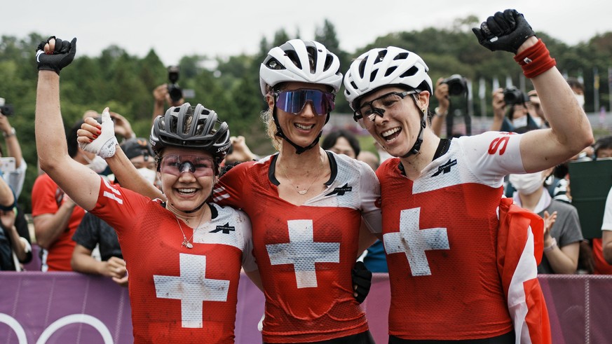 Switzerland&#039;s gold medalist Jolanda Neff center, silver medalist Sina Frei, left, and bronze medalist Linda Indergand (19) celebrate at the finish line after sweeping the podium during the women& ...