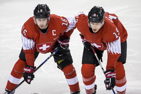 Raphael Diaz of Switzerland, and Reto Schaeppi of Switzerland, from left, during the men ice hockey preliminary round match between Switzerland and Canada in the Kwandong Hockey Center in Gangneung du ...