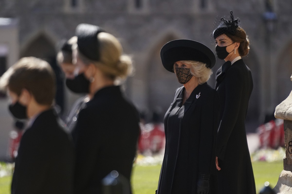 Camilla, the Duchess of Cornwall, second right and Kate, the Duchess of Cambridge stand outside of St George's Chapel ahead of Britain Prince Philip's funeral at Windsor Castle, Windsor, Eng ...