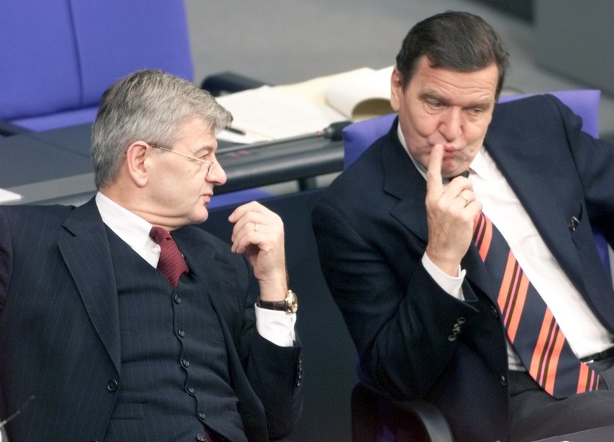 German Foreign Minister Joschka Fischer, left, talks with Chancellor Gerhard Schroeder, right, on the government bench during the debate on the European policy in Berlin Parliament Thursday, October 2 ...