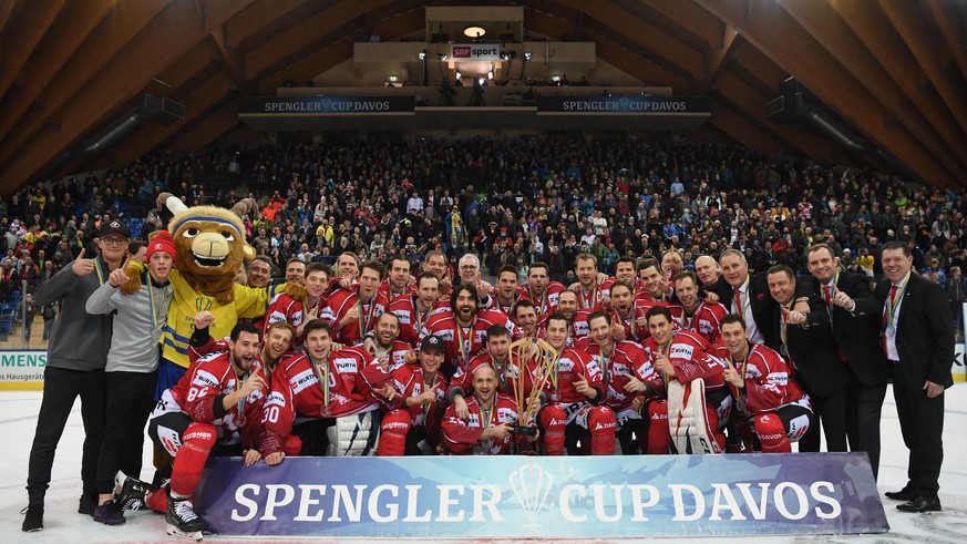 epa08096190 The players and the staff of Team Canada celebrate after winning the final game between Team Canada and HC Ocelari Trinec at the 93rd Spengler Cup ice hockey tournament in Davos, Switzerla ...