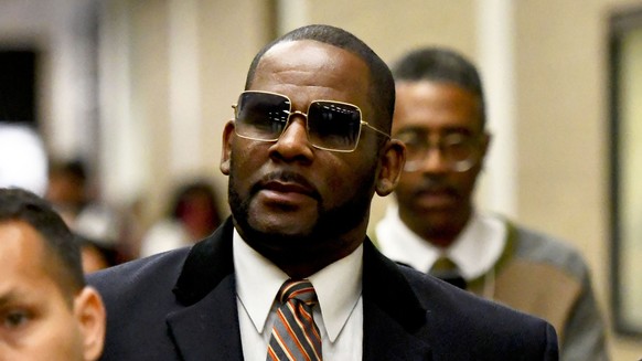 FILE - Musician R. Kelly, center, leaves the Daley Center after a hearing in his child support case on May 8, 2019, in Chicago. Closing arguments are scheduled Monday, Sept. 12, 2022 for R. Kelly and  ...