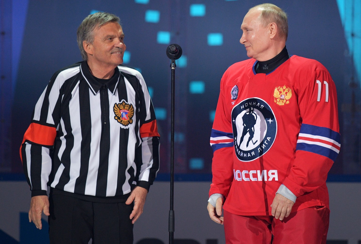 epa09189646 Russian President Vladimir Putin (R) and IIHF (International Ice Hockey Federation) President Rene Fasel (L) take part in a gala match with the participation of Russian hockey legends as p ...