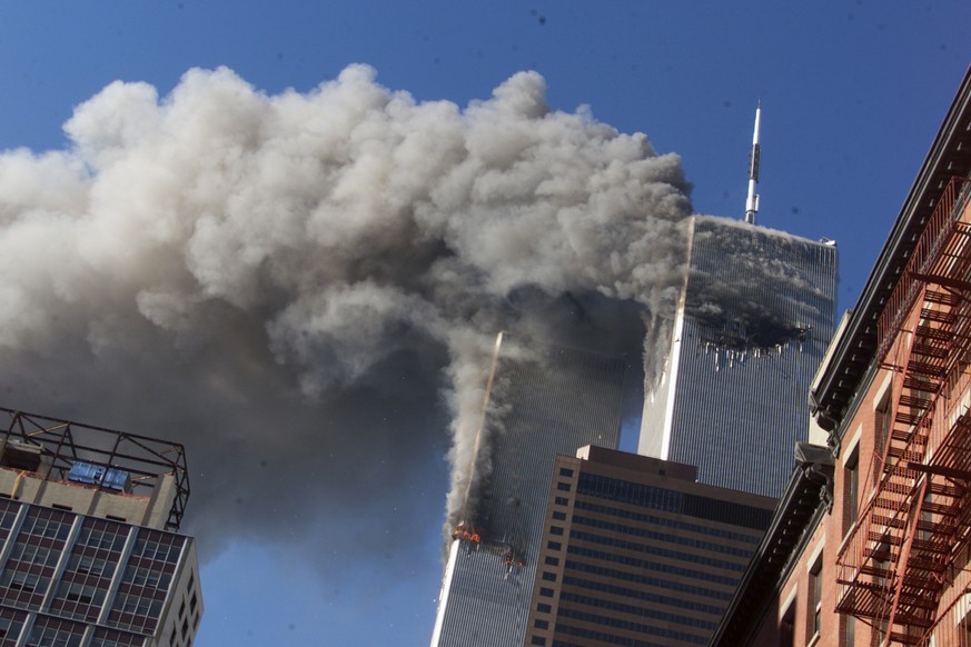 FILE - In this Sept. 11, 2001, file photo, smoke rises from the burning twin towers of the World Trade Center after hijacked planes crashed into the towers in New York City. Sept. 11 victimsÄô relati ...