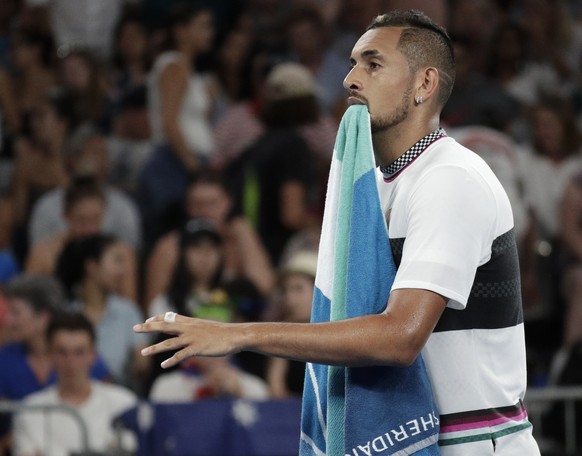 Australia&#039;s Nick Kyrgios walks with his towel in his mouth as he changes ends during his first round match against Canada&#039;s Milos Raonic at the Australian Open tennis championships in Melbou ...