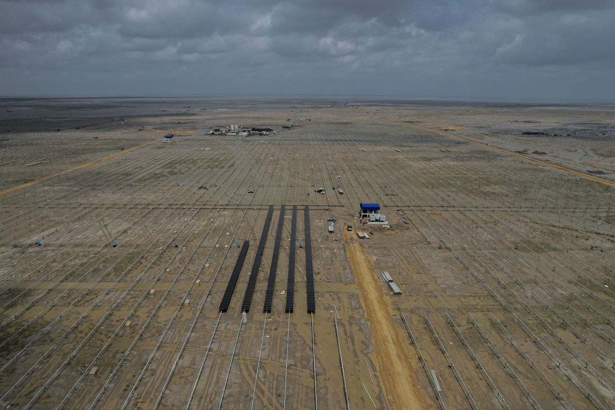 Solar panels are installed at an under-construction site of Adani Green Energy Limited's Renewable Energy Park in the salt desert of Karim Shahi village, near Khavda, Bhuj district near the India ...