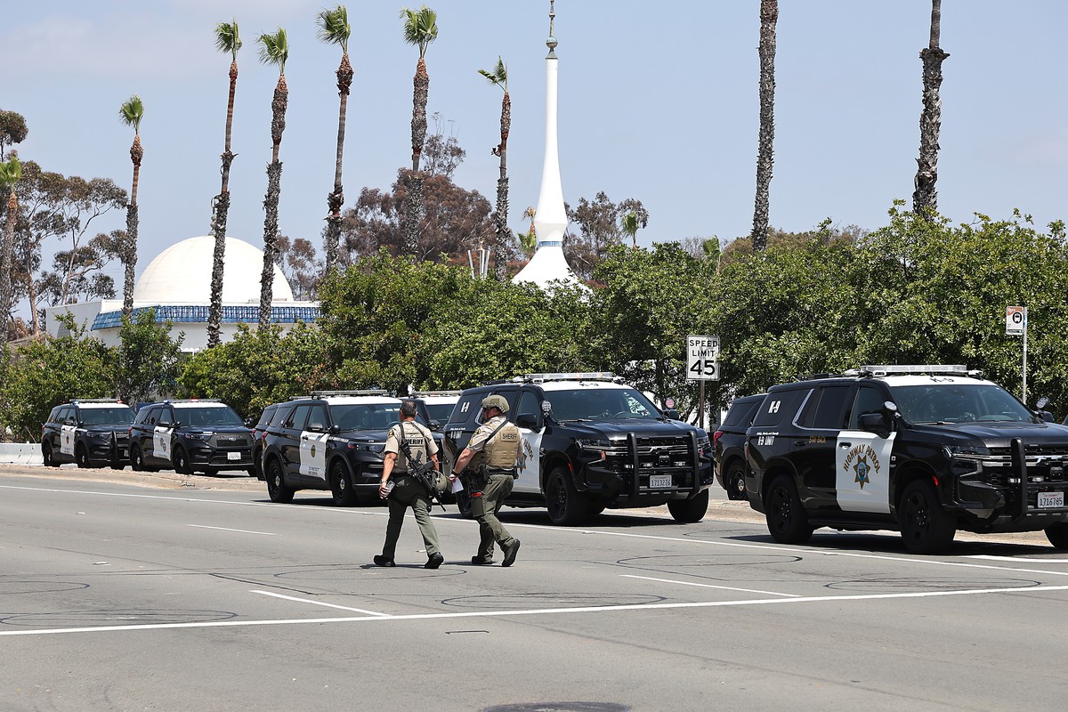 epa12972643 Law enforcement personnel gather on the scene to respond to an active shooting incident at the Islamic Center of San Diego, located in the Clairemont neighborhood in San Diego, California, ...