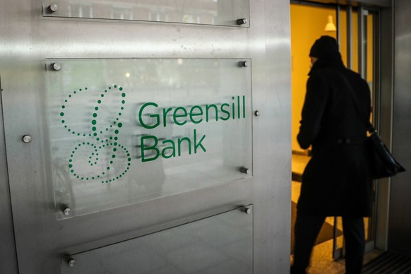 epa09050565 A person enters the Greensill Bank in Bremen, northern Germany, 04 March 2021. The German Federal Financial Supervisory Authority (BaFin) has banned the bank from regular operations on 03  ...