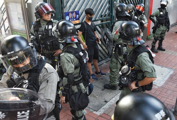 epa07969349 Riot police surround a protester to check his ID, during a rally against police brutality at a shopping mall in Hong Kong, China, 03 November 2019. Hong Kong has entered a 22nd week of ong ...
